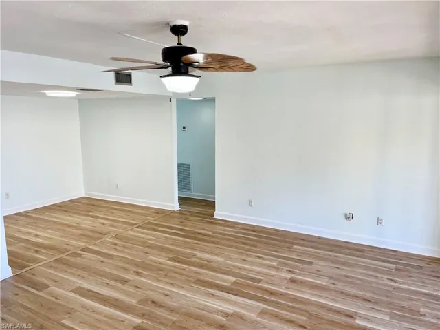 Spare room with light hardwood / wood-style floors and ceiling fan