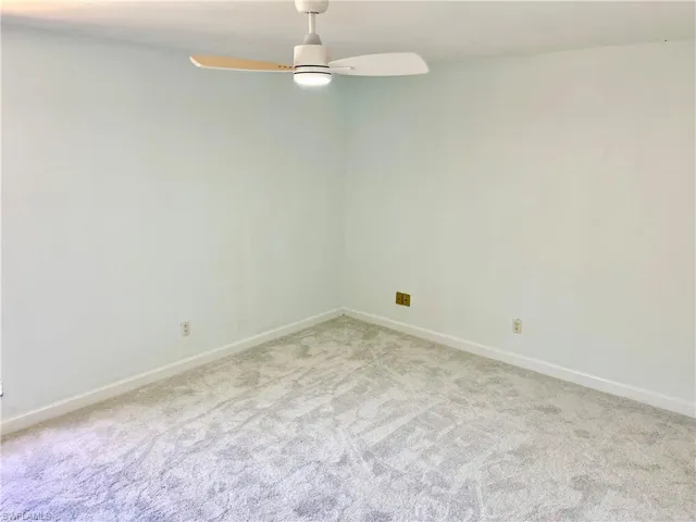 Unfurnished room featuring light carpet and ceiling fan