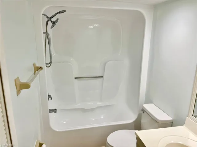 Full bathroom with vanity, shower / bathing tub combination, and toilet