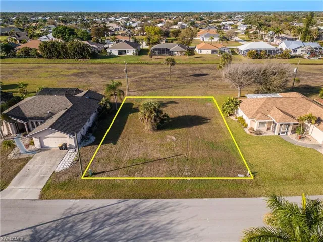Aerial view of residential area featuring property boundaries highlighted