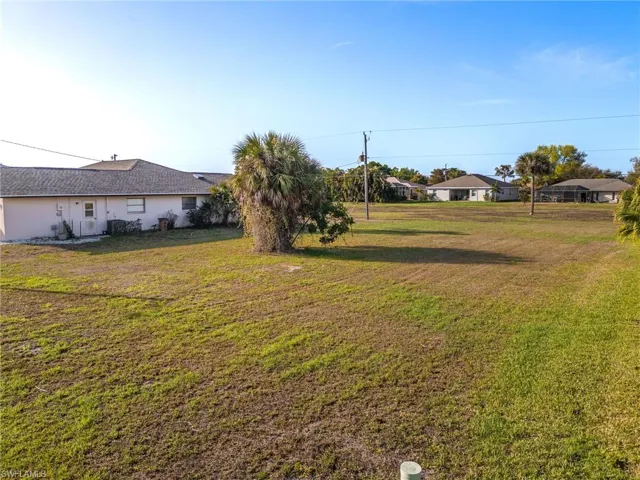 View of green lawn featuring a residential view
