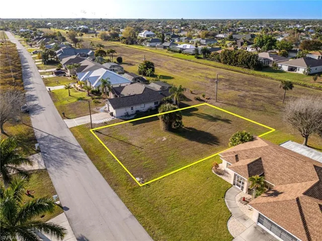 Aerial perspective of suburban area featuring property boundaries highlighted