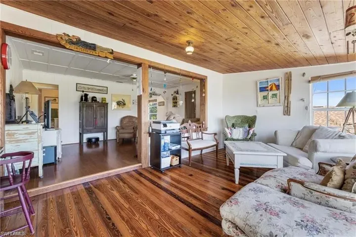 Living room with hardwood/wood-style flooring, and wood ceiling
