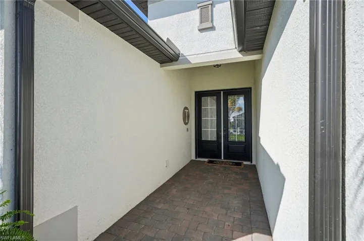 Entrance to property with french doors and stucco siding
