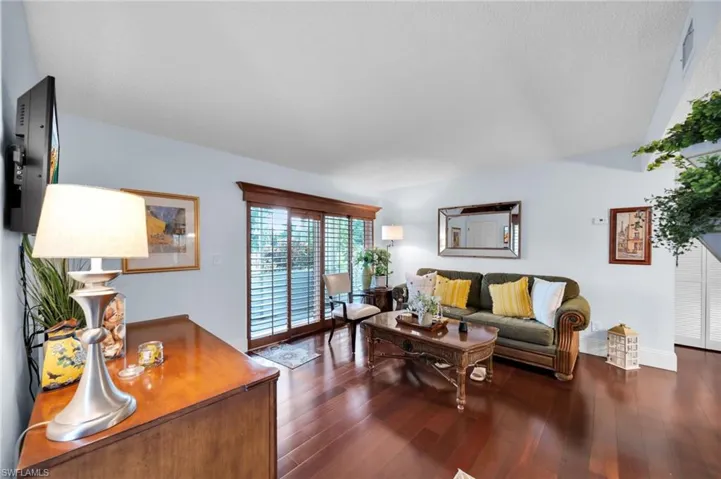 Living room with dark wood finished floors and baseboards