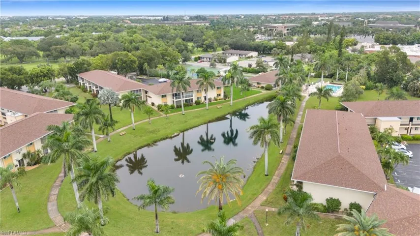 Aerial perspective of suburban area featuring a nearby body of water