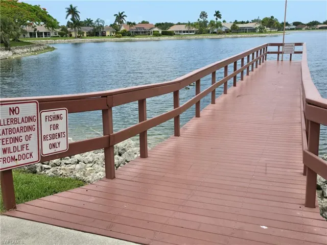 Dock area with a residential view and a water view