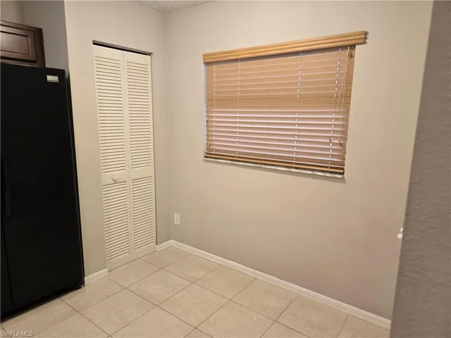 Breakfast nook & Pantry closet, light tile patterned floors, and a textured ceiling
