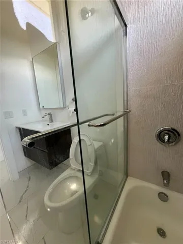Full bathroom with toilet and vanity