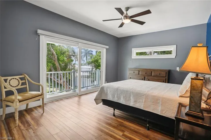 Bedroom featuring ceiling fan, access to outside, and hardwood / wood-style flooring
