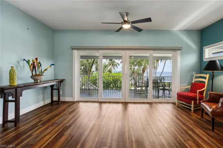Living area featuring wood-type flooring and ceiling fan