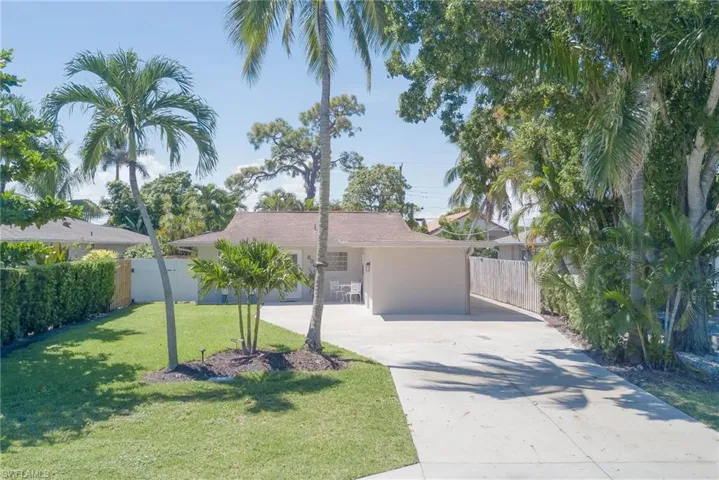 Ranch-style house featuring concrete driveway and stucco siding