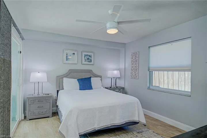 Bedroom with a ceiling fan and light wood-type flooring