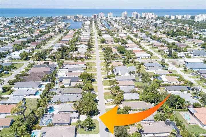 View of property location with a nearby body of water and nearby suburban area