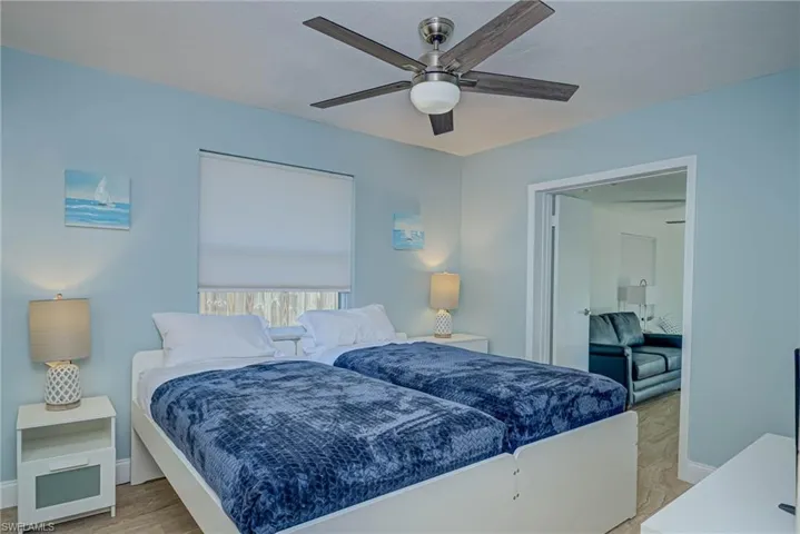 Bedroom with ceiling fan and baseboards