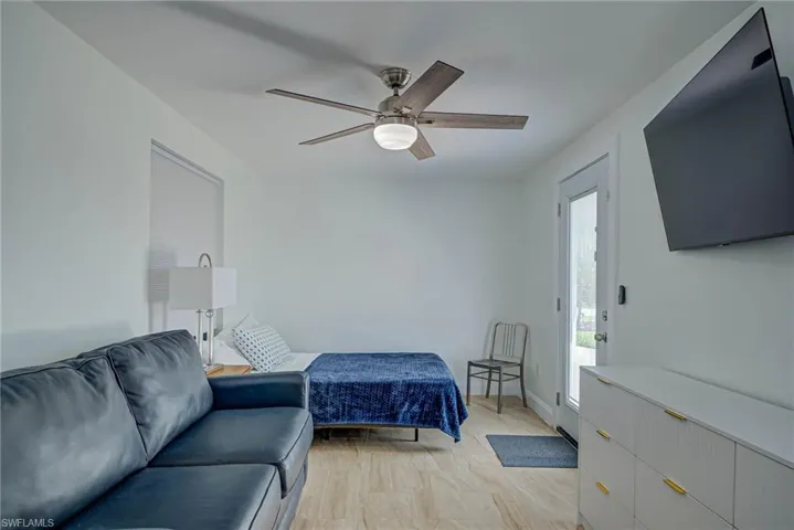 Bedroom with access to exterior and a ceiling fan
