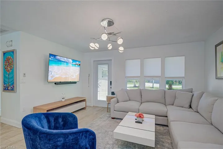 Living area with light wood-style flooring and baseboards