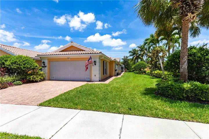 View of front of home with a front yard and a garage and plenty of space with the OVERSIZE LOT.