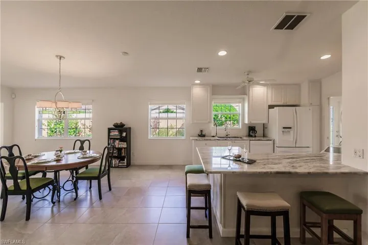Kitchen with 4 bar stools is adjacent to the Dining Area.