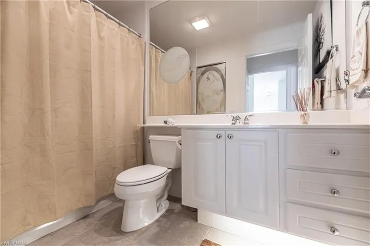 2nd en-suite Bathroom featuring vanity, toilet, and tile floors