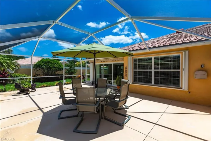 View of sunroom / solarium.  All windows have Accordion Shutters for easy closing plus the Door Wall has Hurricane Rated Impact Glass!