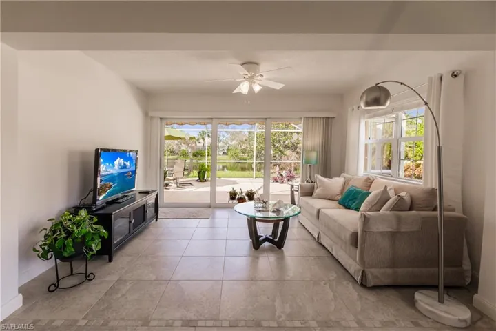 Tiled sun room with Hurricane Impact Sliding Door overlooking the outdoors.