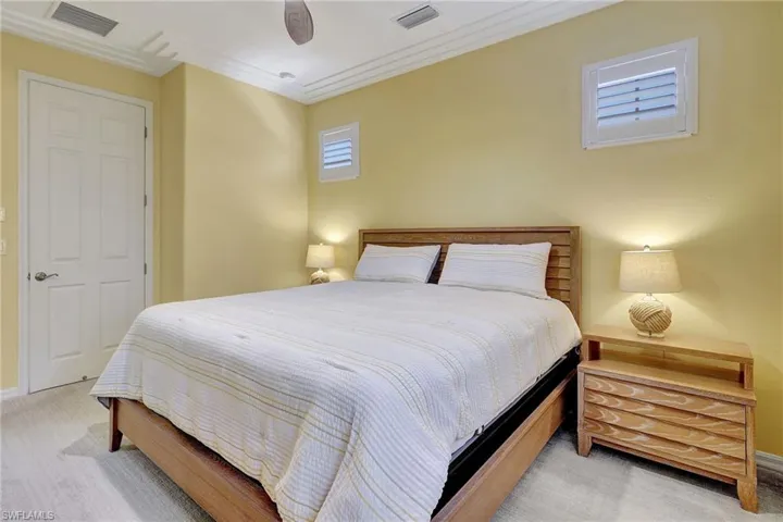 Bedroom featuring ornamental molding and light carpet
