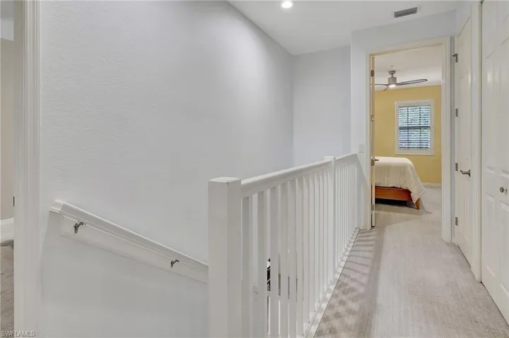 Hallway with light colored carpet
