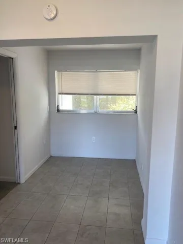 Tiled spare room with a wealth of natural light