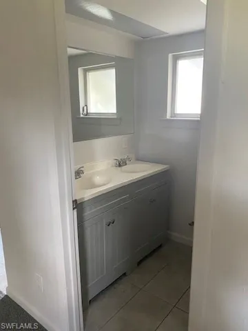 Bathroom featuring tile patterned flooring and vanity