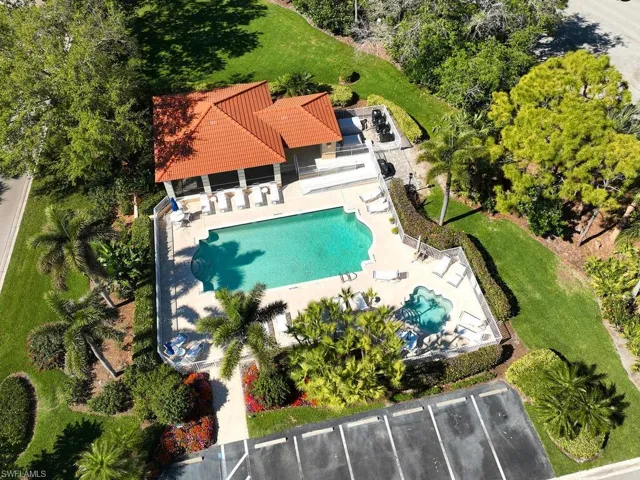 Resort-style pool area surrounded by lush tropical landscaping.