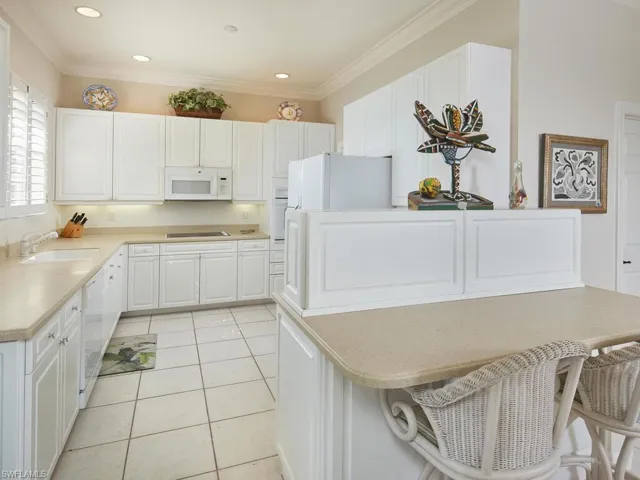 Spacious kitchen with white cabinetry and plenty of counter space.