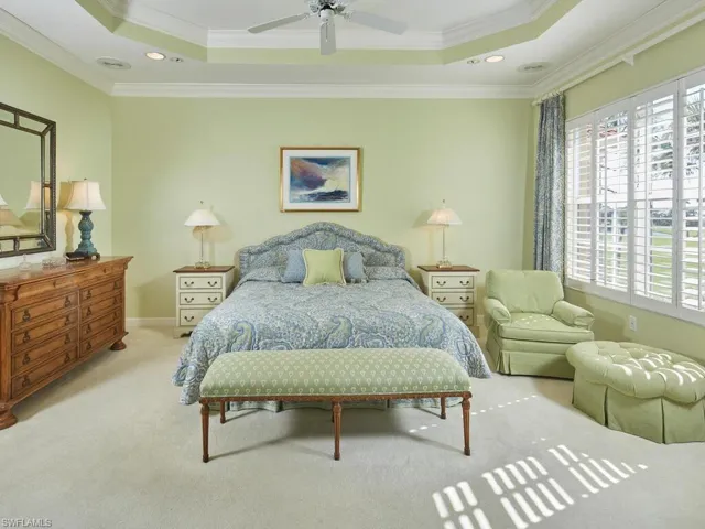 Inviting primary bedroom with tranquil views and private access to the lanai.