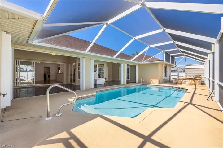Pool featuring a patio and glass enclosure