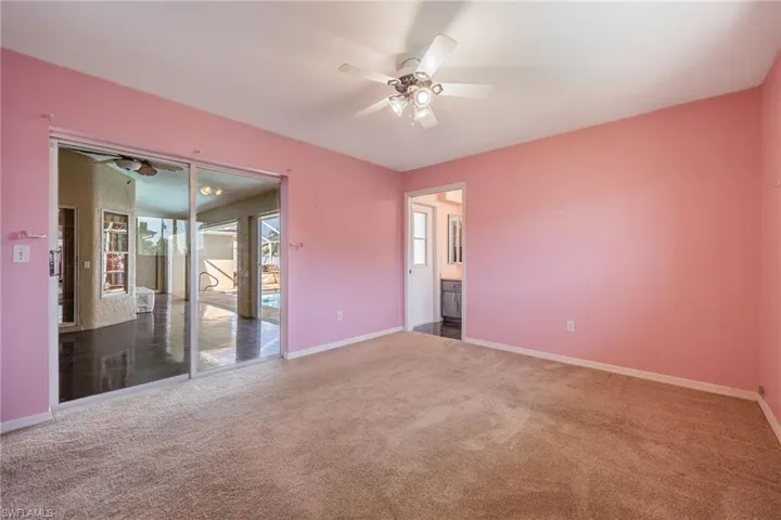 Unfurnished bedroom with baseboards, a ceiling fan, and carpet