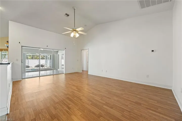 Unfurnished room with light wood-style floors, ceiling fan, baseboards, and visible vents