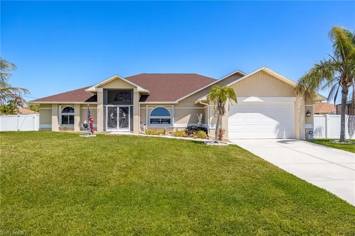 Ranch-style home with a garage, a front yard, fence, and concrete driveway