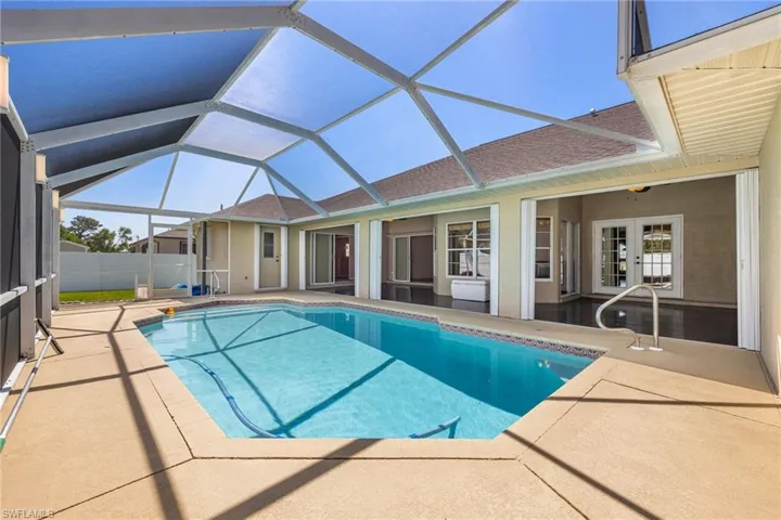View of swimming pool with a fenced in pool, a patio area, french doors, and a lanai