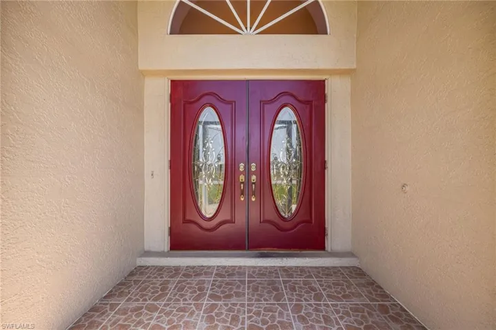 View of exterior entry with stucco siding