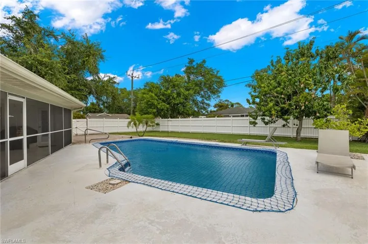 View of swimming pool featuring a patio and a sunroom