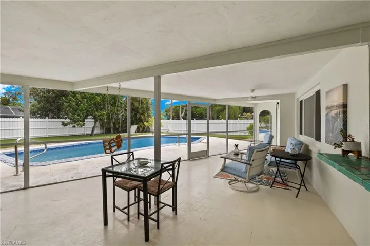 View of swimming pool featuring a patio area and ceiling fan