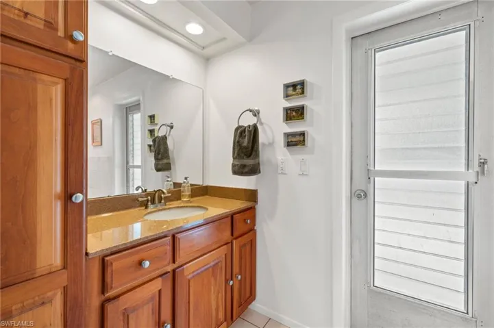 Bathroom featuring tile floors and vanity