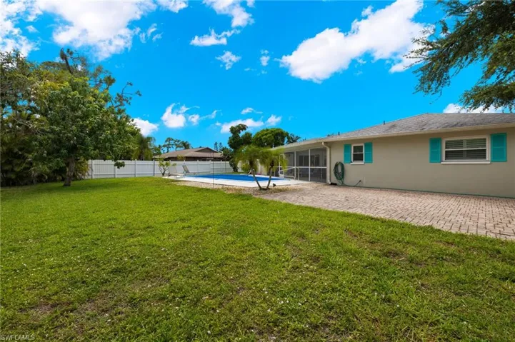 View of yard with a fenced in pool