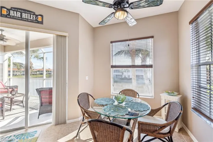 Tiled dining space featuring ceiling fan