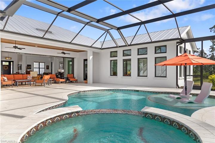 Screened Lanai with motorised Sun Shade, salt water pool with Full moon sun shelf, and spa