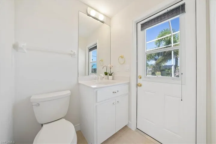Half bath/pool bat featuring vanity and light tile patterned flooring