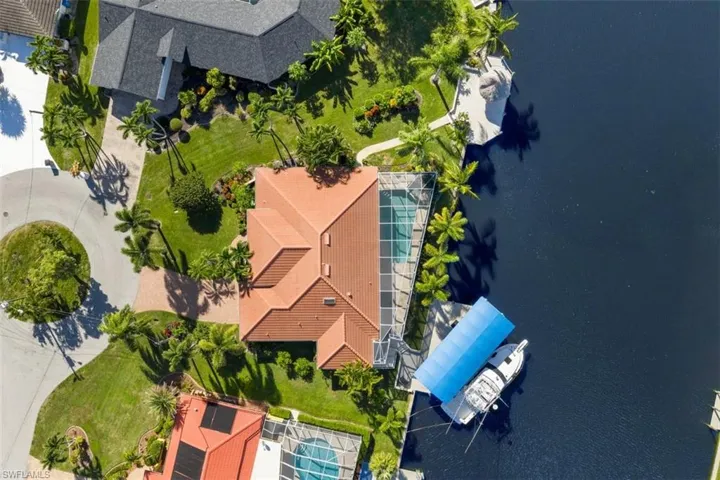Bird's eye view of a large body of water, 2 docs and intersecting canal view.