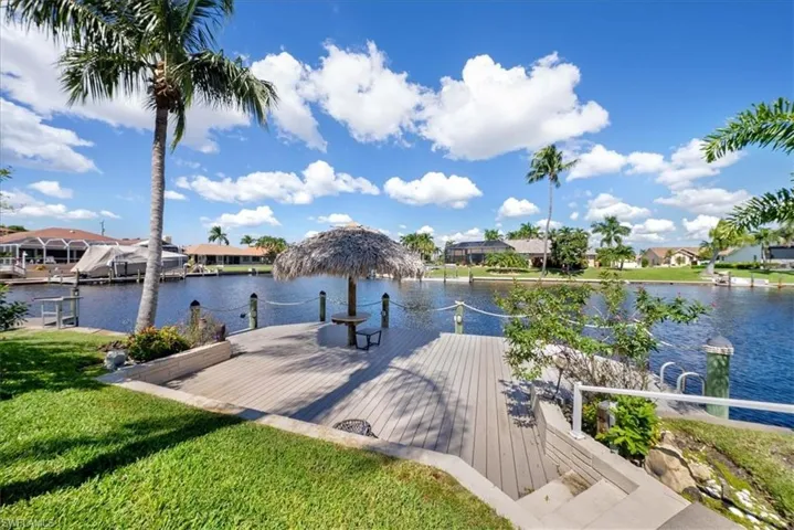 Dock area featuring a water view with intersecting canals with your very own tiki bar