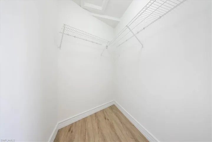 Walk in closet featuring light wood-style flooring