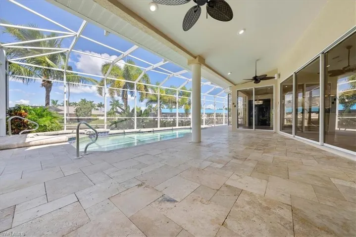 Outdoor pool featuring a patio, ceiling fan, a spa.